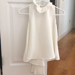 White flowy top ruffle detail at neck